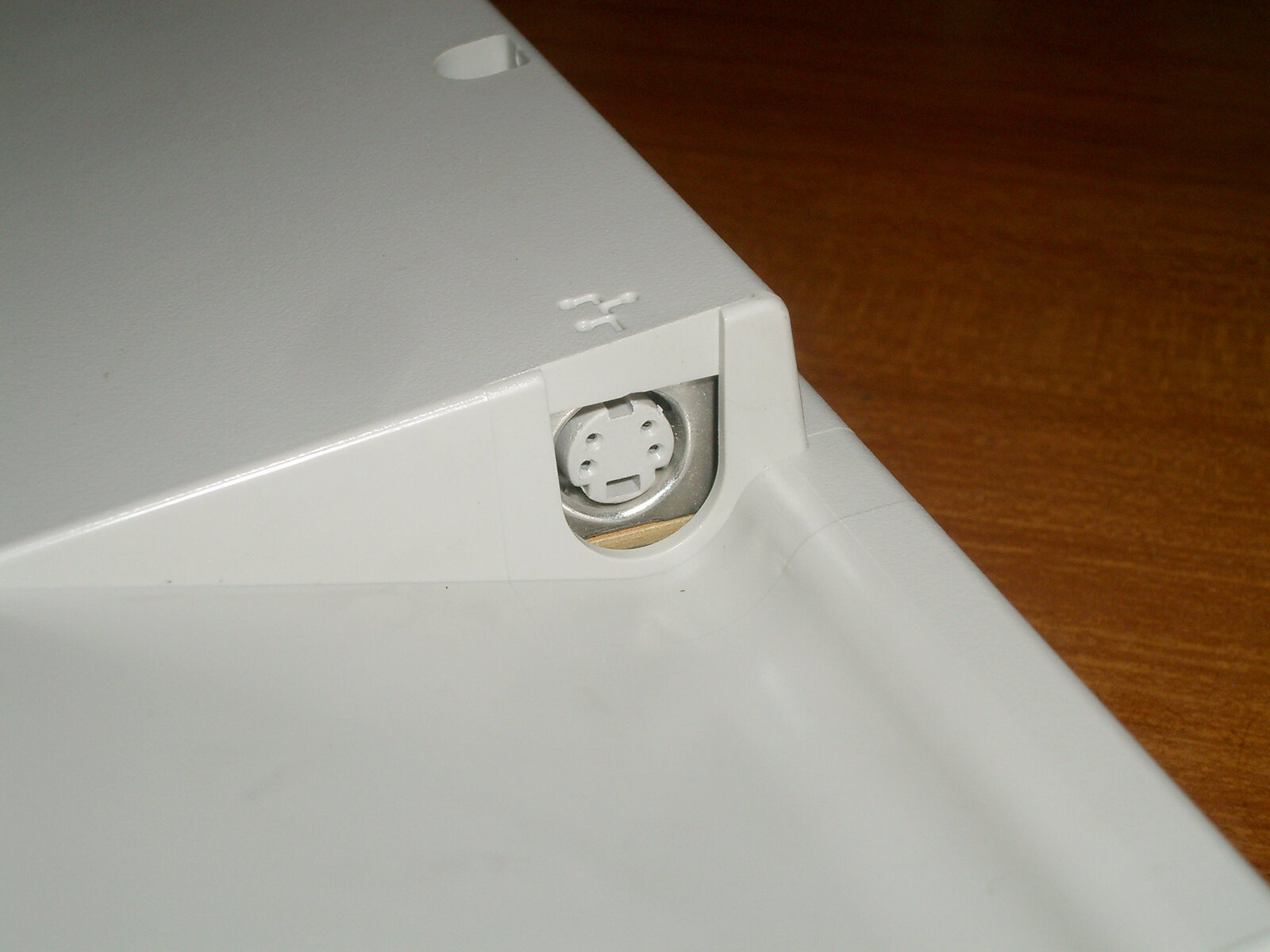 A close-up of an Apple Desktop Bus port