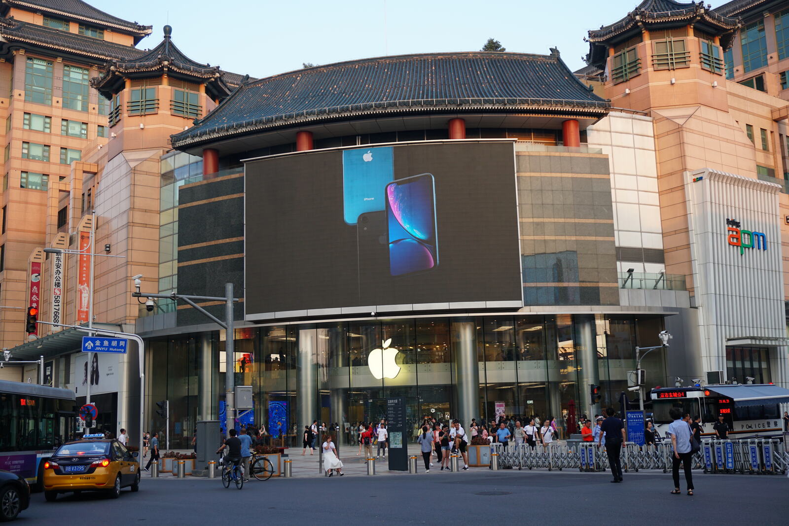 A huge circular screen over the plaza, showing off the iPhone.