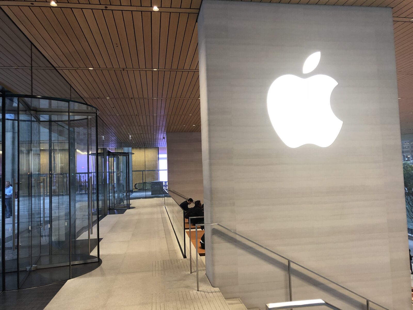 The “MacBook lid” roof, 32-foot glass walls, and the logo on the core.