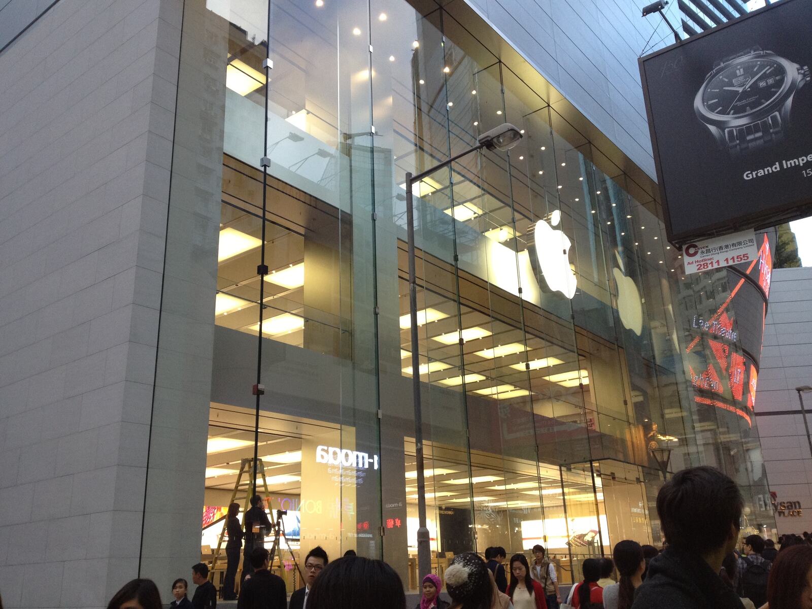 The glass front glowing over the Causeway Bay crowds at night.