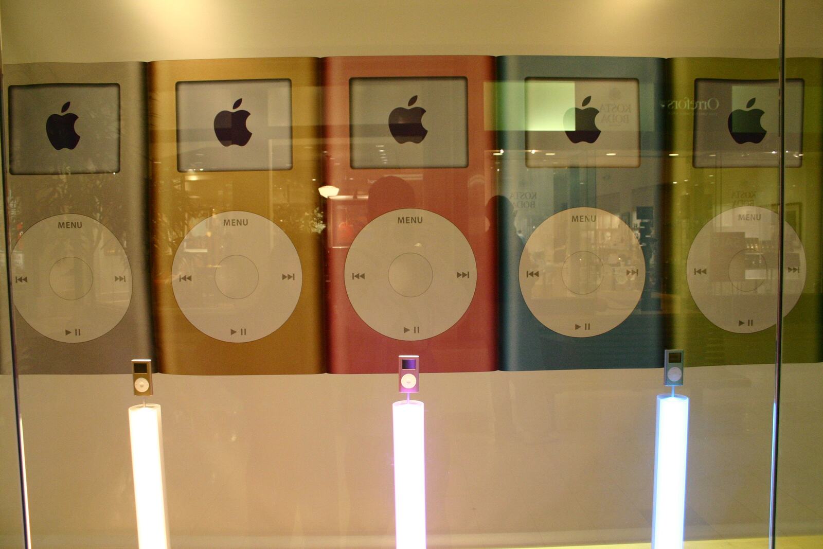 The colourful second-generation iPod nano up close behind glass.