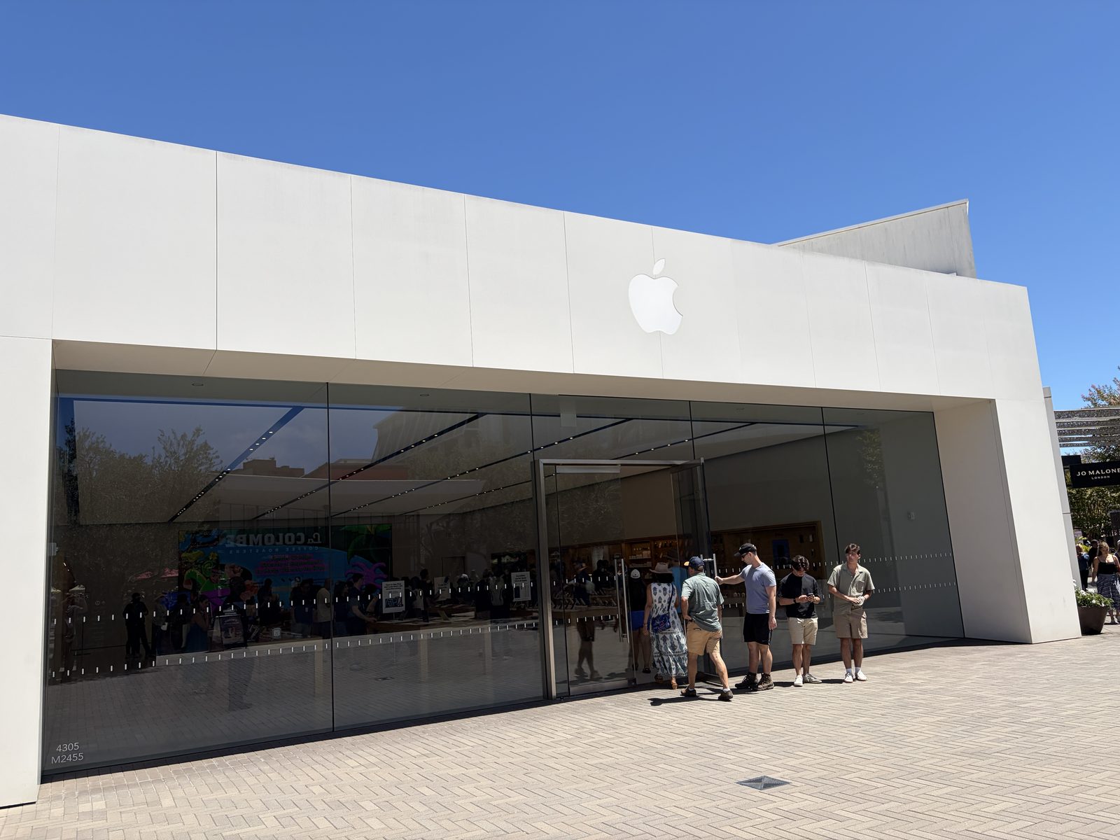 The stone-and-glass front of Apple UTC on the Westfield plaza, Jo Malone next door.